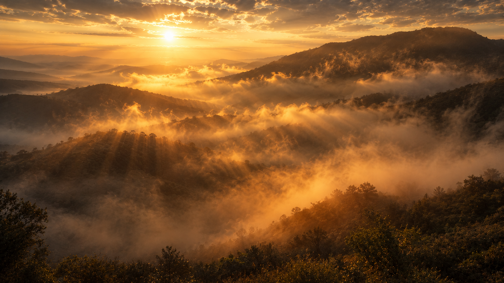 Mountain mist rising at dawn with shafts of golden light breaking through, evoking creation's labor pains at Romans 8:22